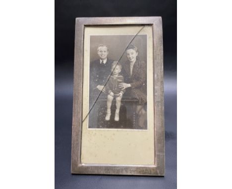 George V silver engine turned rectangular photograph frame, London 1927, 22cm x 12.5cm.