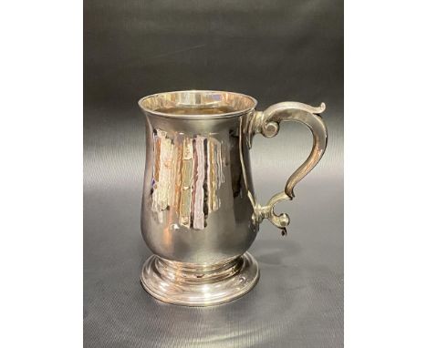 Good George III silver baluster footed mug with scroll handle, maker's mark .K (partial mark possibly John King), London 1776