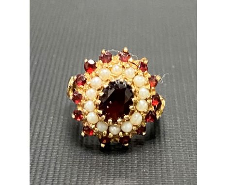 9ct gold ruby and pearl set cluster ring, the central ruby of 0.75ct spread approx, weight 5.5g approx.