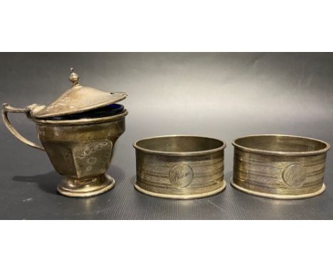 Pair of silver engine turned napkin rings together with a silver pedestal lidded mustard pot, weight of silver 2.30oz approx.