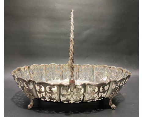 Good Victorian swing handled oval bread basket by George Howson, with twisted swing handle, the lobed sides foliate scroll pi