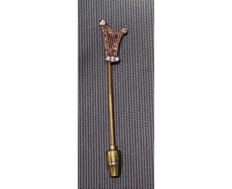 Diamond set stick pin in the form of a harp set with five brilliant cut small diamonds and the harp frame with old cut brown 