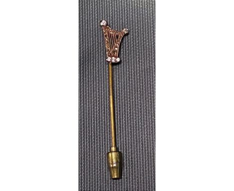 Diamond set stick pin in the form of a harp set with five brilliant cut small diamonds and the harp frame with old cut brown 