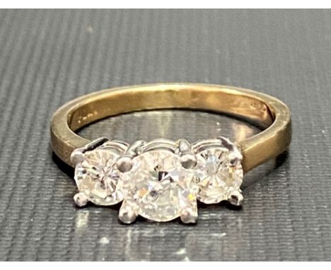 Modern 14ct gold and platinum diamond three stone ring, the centre diamond of 0.50ct spread approx, the side diamonds each of