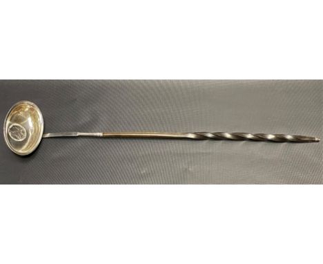 George III silver toddy ladle with twisted baleen handle, the oval bowl inset with a George III 1787 shilling, length 41cm