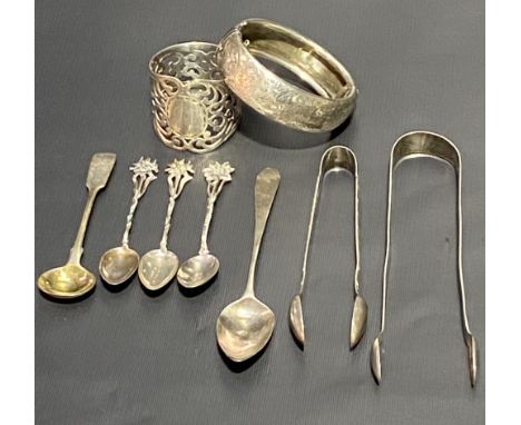 Miscellaneous silver, to include a Victorian silver hallmarked bangle, Chester 1878, George III bright cut sugar tongs, anoth