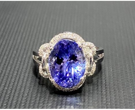 Modern 18ct white gold tanzanite and diamond set cluster ring, the tanzanite of 4.66ct spread approx, the diamonds of 0.15ct 