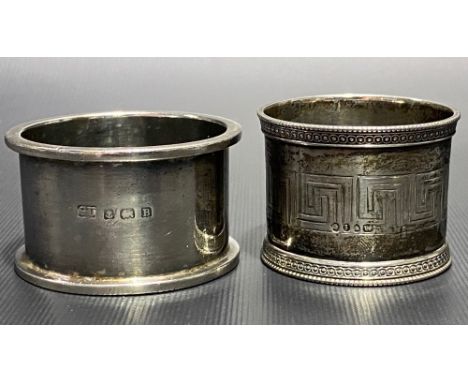 Victorian silver napkin ring with Greek key engraved decoration, London 1864; together with a George V silver plain heavy nap