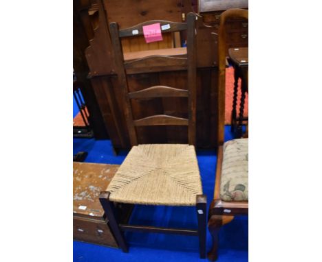 A traditional ladder back chair with strung seat