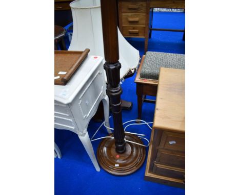 A traditional mahogany standard lamp, with shade