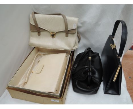 Four lady's vintage hand bags including Riviera (with original box), Winsley navy leather and two vintage parasols in red and