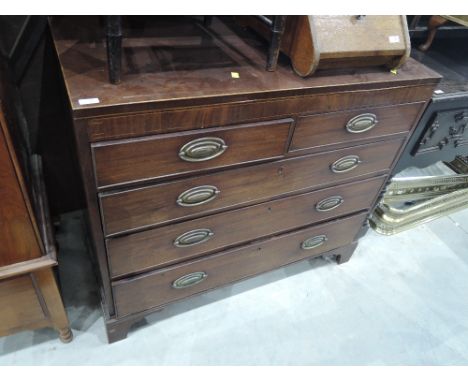 An early 19th century mahogany chest of two short and three long cockbeaded drawers on bracket feet