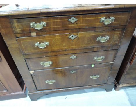 An early 19th century mahogany chest of 4 long tapered drawers having line inlay decoration and bracket feet