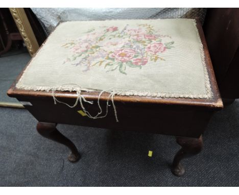 An early 20th century mahogany piano stool having tapestry top, box seat and cabriole legs, containing sheet music
