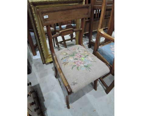 An early 19th century mahogany Regency chair having rail back with later tapestry seat and sabre legs 