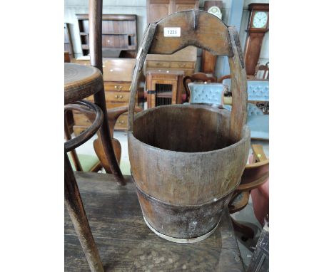 A vintage treen pail having integral handle and metal band