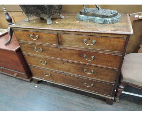An early 19th century oak chest of two short and three long cockbeaded drawers, on bracket feet
