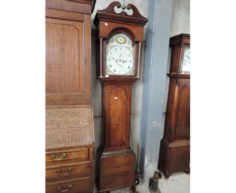 A late 18th century oak and mahogany longcase clock having swan neck and pillar hood containing arch painted dial and 8 day m