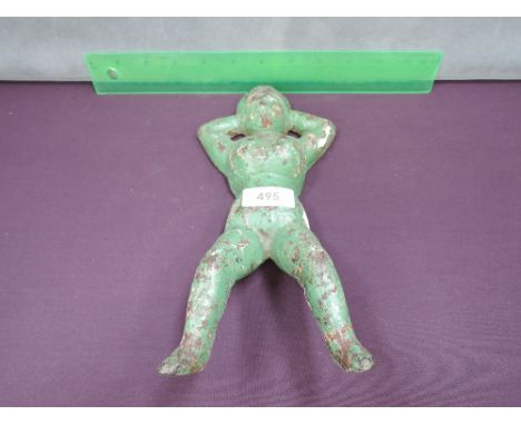 A vintage cast iron bootjack figure modelled as Naughty Nellie, Kimbo lady