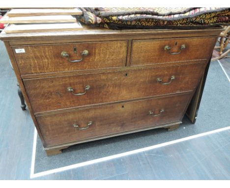 An early 19th century oak chest of two short and two long cockbeaded drawers on later bracket feet
