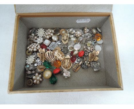 A vintage composite box containing a selection of vintage clip and screw back earrings