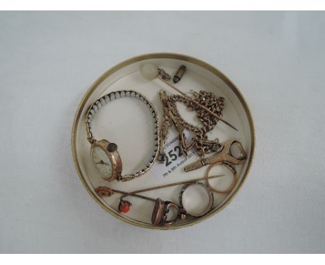 A selection of yellow metal jewellery including wrist watch, marcasite ring, stick pins, fob, watch chain etc