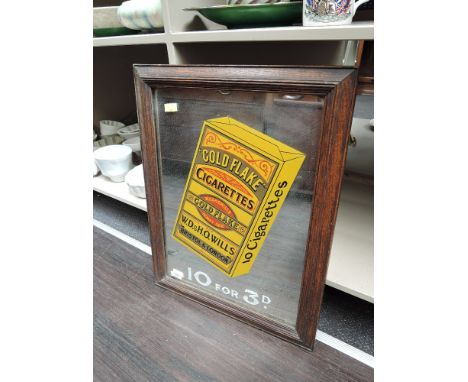 A vintage advertising mirror for Wills Gold Flake cigarettes, in oak frame