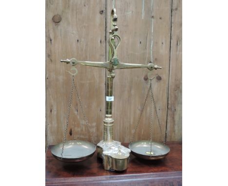 A brass weighing scale of traditional form