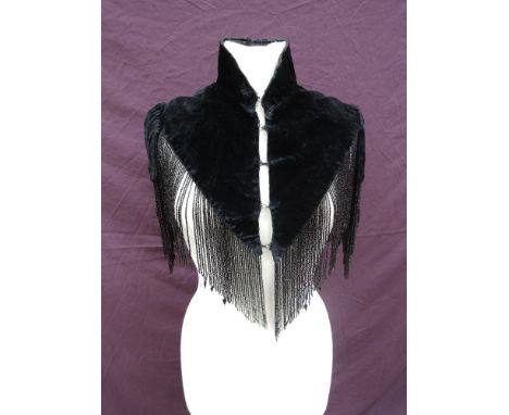 A vintage heavily beaded black velvet evening shoulder cape having black bead tassels