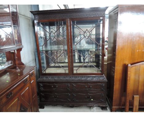 A late Victorian dark mahogany display cabinet having blind fret decoration to cornice section over double astral glaze mirro