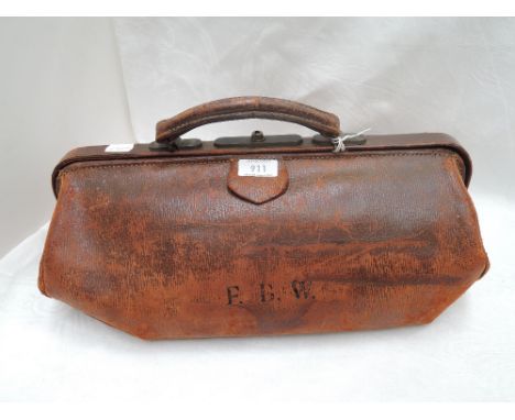 A vintage tan leather Gladstone bag having a checked cotton lining and monogrammed FBW to side