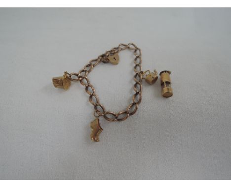 A 9ct rose gold charm bracelet having padlock clasp and  3 & 1 charms including miners lamp,  approx 21.1g