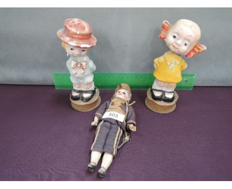 A 19th century bisque head doll of small size, in later costume, indistinctly stamped and two vintage plaster Noddy dolls