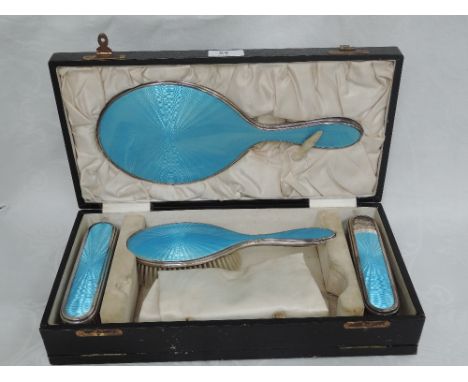 A cased silver dressing table set having turquoise enamel guilloche decoration, Birmingham 1923, Adie Brothers, one hair brus