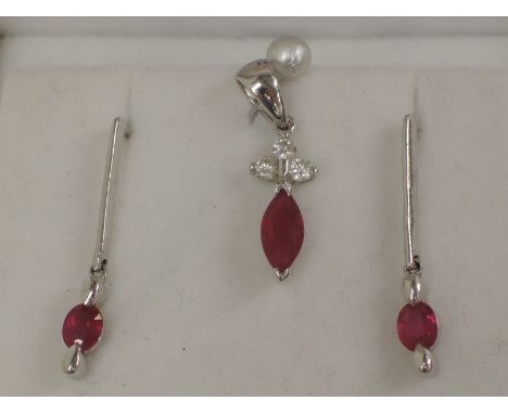 An 18ct white gold pendant having a marquise cut ruby and three brilliant cut diamonds (no chain) with matched 18ct white gol