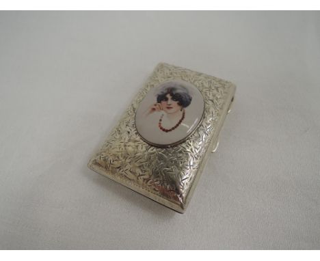 An Edwardian silver cigarette case having foliate engraved decoration and an enamelled panel depicting an lady in profile, Bi