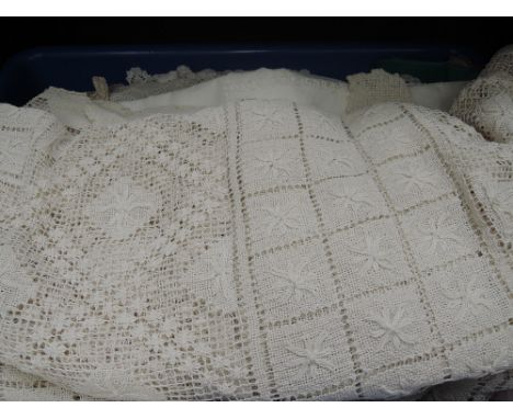 A collection of vintage linen and lace including large Irish linen tablecloth with shamrock decoration, place mats, crocheted