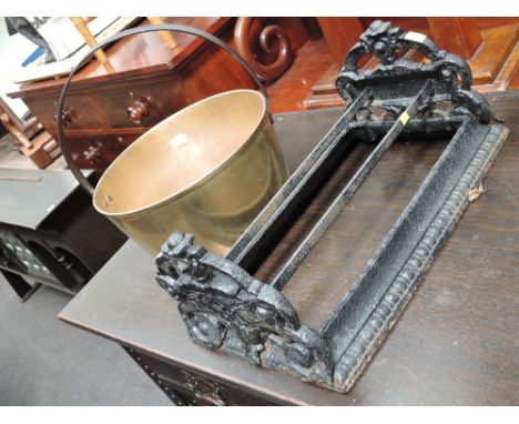 A Victorian cast iron, black painted boot scrapper and a vintage brass jam pan