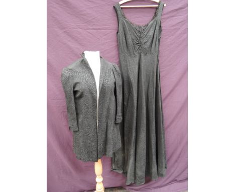 A vintage black sleeveless evening dress with gored full length skirt and lace trimmed bodice, with matched hand made jacket