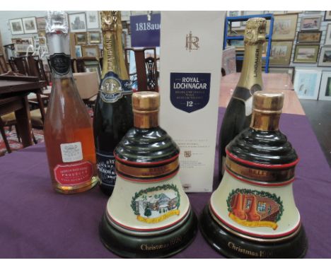 A mixed box of 3 bottles of sparkling wine, 2 ceramic decanters of Bell's whisky and one bottle of Royal Lochnagar