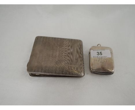 A silver cigarette case having engine turned striped decoration, Birmingham 1927, William Neale & Son Ltd and a Victorian sil