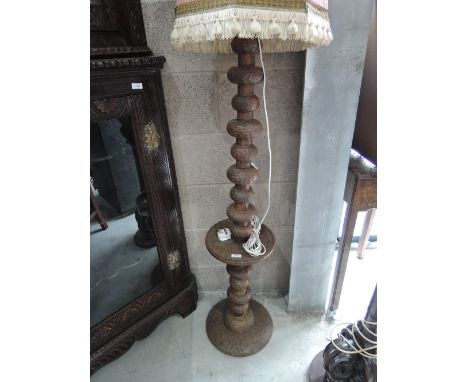 A treen standard lamp of Middle Eastern design having chip carved bobbin column 