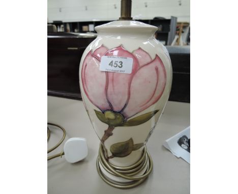 A Moorcroft table lamp of baluster form having magnolia pattern on cream ground