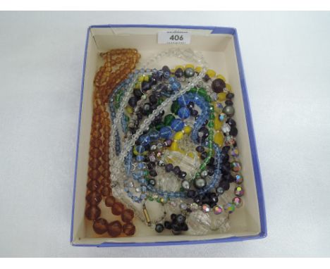 Ten strings of vintage cut glass beads of various colours and forms
