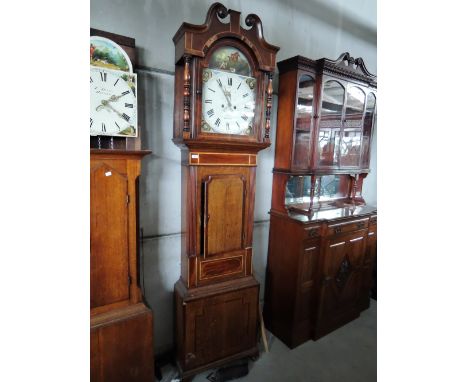 An early 19th century mahogany and oak longcase clock having swan neck and pillar hood containing painted arch dial and 8 day