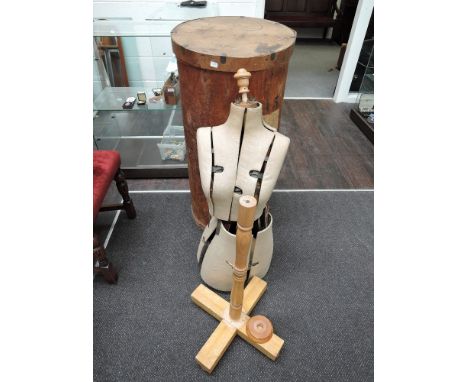 A vintage tailor's dummy, in cylindrical plywood box
