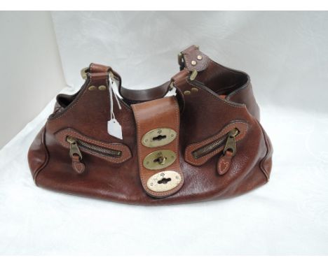A vintage brown leather Mulberry handbag ref no: 146356 having brown cloth lining bearing Mulberry tree emblem and internal z