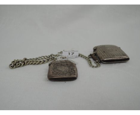 Two HM silver vestas having scroll and engine turned decoration attached to a white metal watch chain 