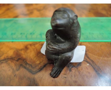 A miniature bronze figure modelled as an Ape and baby