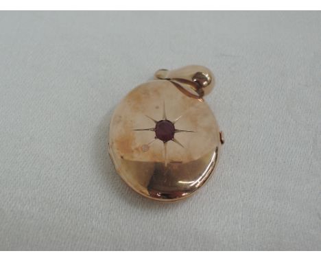 A 9ct rose gold oval locket having oval ruby insert,  approx 7.3g